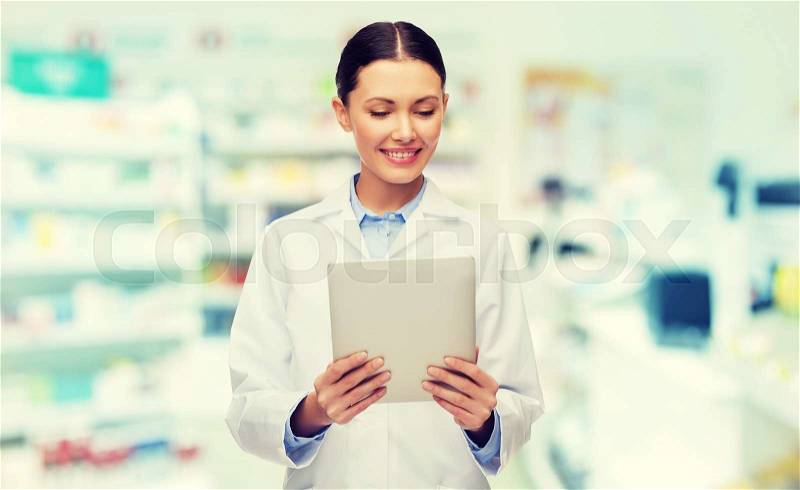 Medicine, pharmacy, people, health care and pharmacology concept - smiling female doctor with tablet pc computer over drugstore background, stock photo