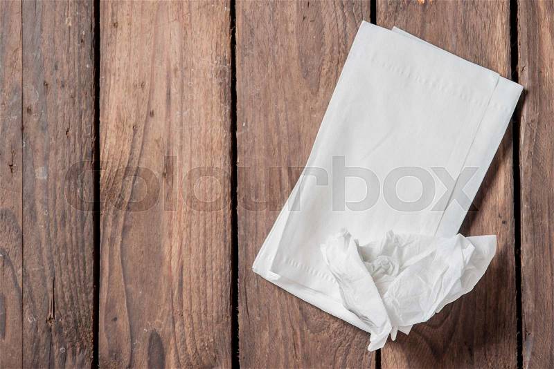 White Paper Napkins on old wooden table, stock photo