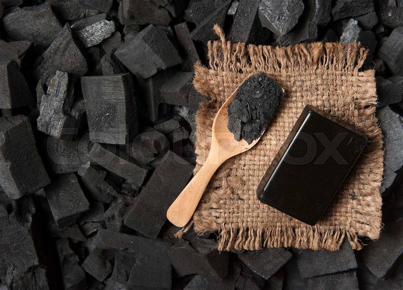 Block of natural carbon soap and Black charcoal texture background, stock photo