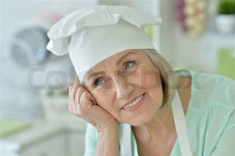 Portrait of a senior chef woman happy , stock photo