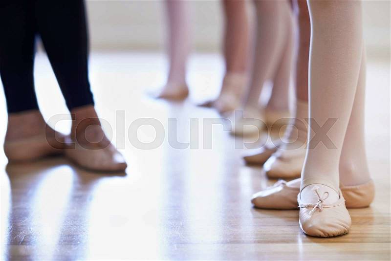 Close Up Of Teacher And Children\'s Feet In Ballet Dancing Class, stock photo