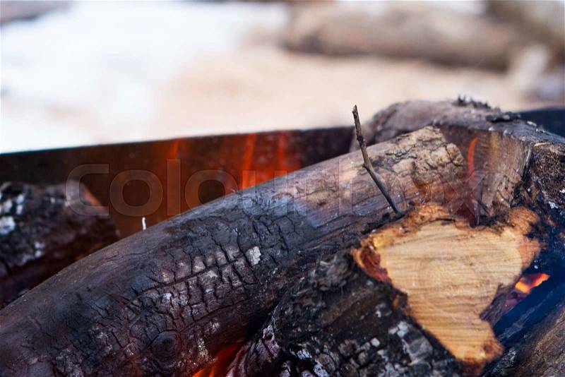 Flames and smoke from burning wood Burning firewood with ashes and flames close-up, stock photo