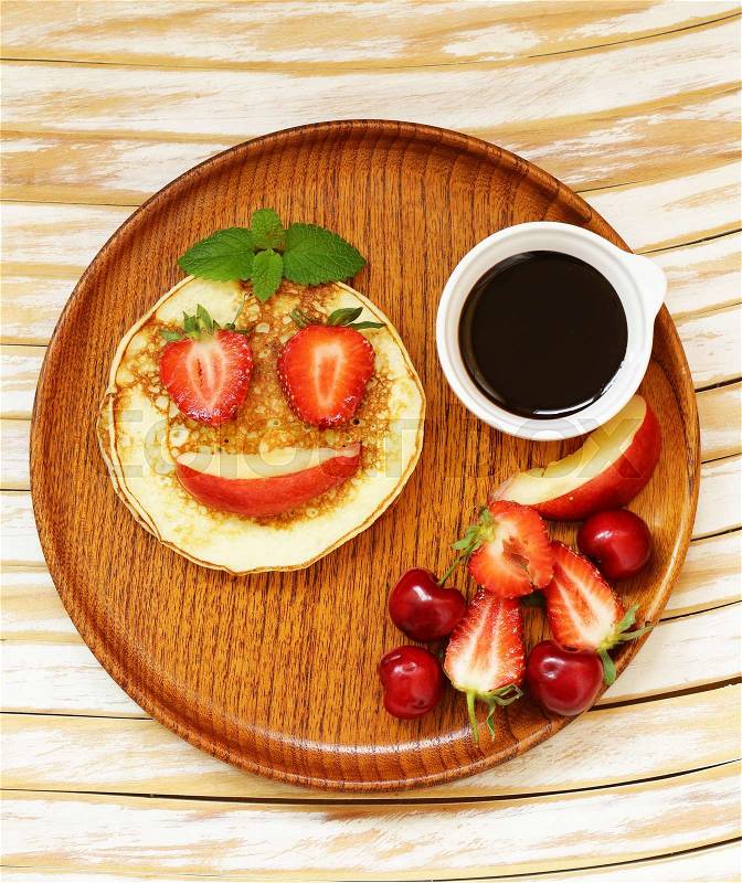 Breakfast pancakes with berries (strawberry, cherry, banana), funny face, stock photo