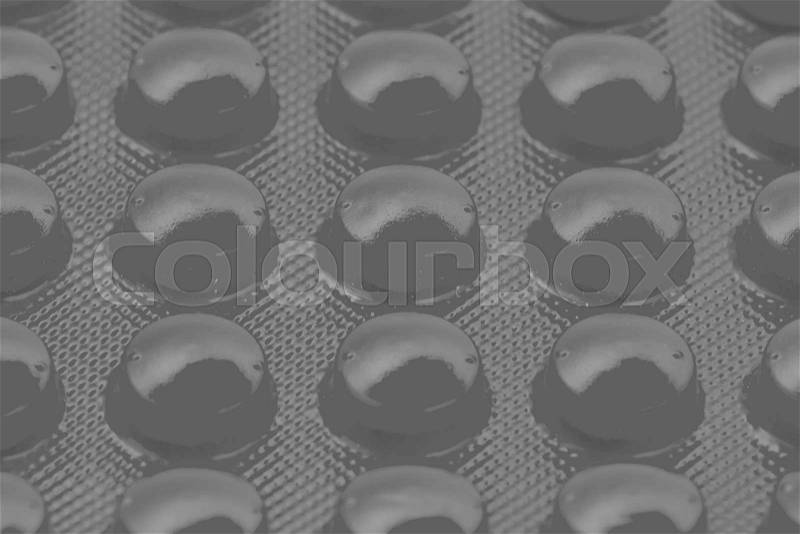 Black pills in blister pack can be used as background, stock photo