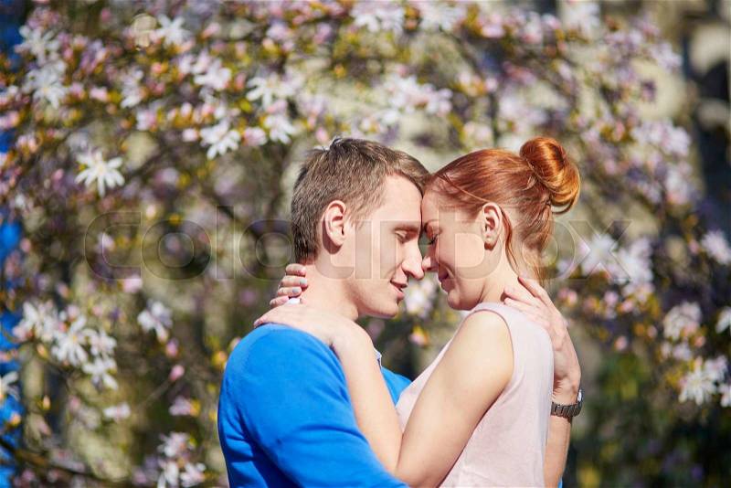 Romantic couple in flowering garden in Paris, France, stock photo
