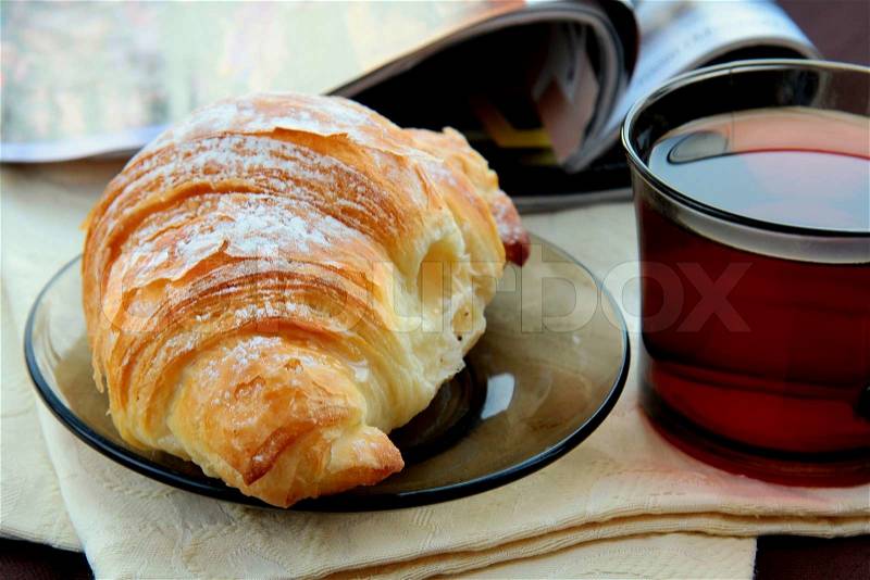 Croissant and a cup of tea French breakfast, stock photo