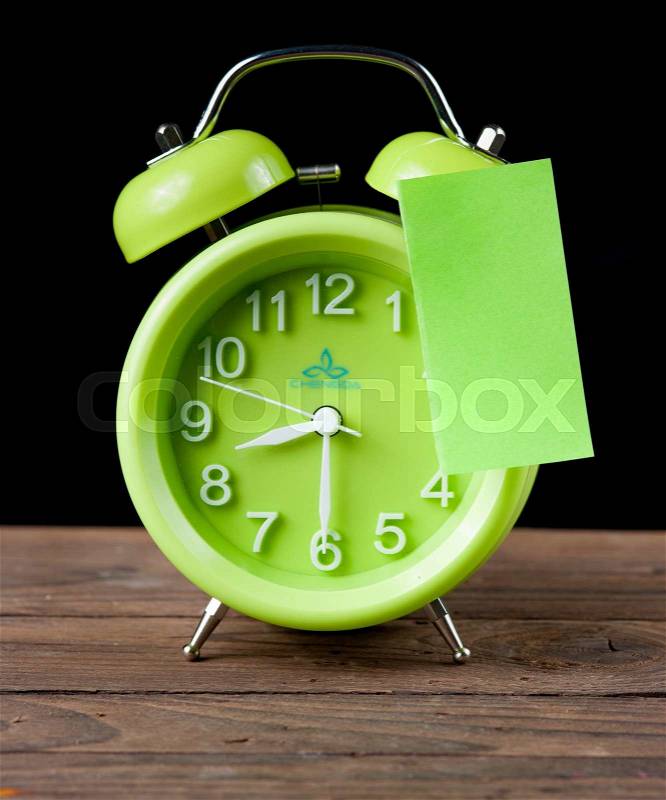 Green alarm clock and sticky paper with Text Space isolated on white background,dark background, stock photo