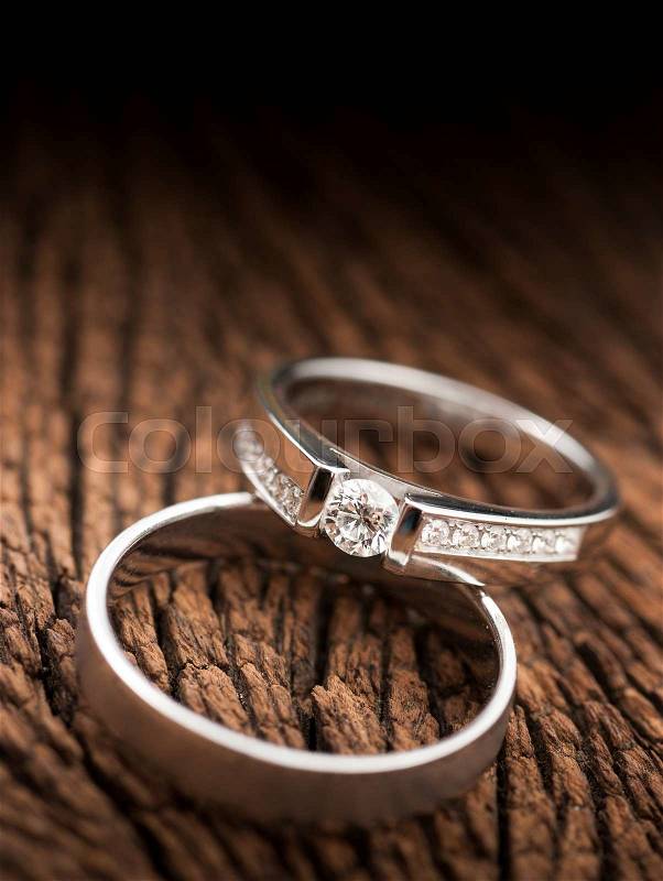 Wedding rings on wood, stock photo