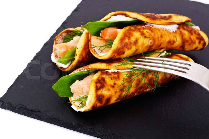 Pancake Rolls with Salmon Fried, Goat Cheese, Fennel and Wild Garlic Leaves Studio Photo, stock photo