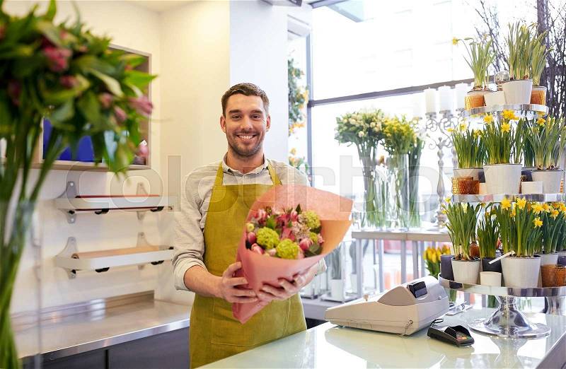 People, business, sale and floristry concept - happy smiling florist man with bunch at flower shop, stock photo