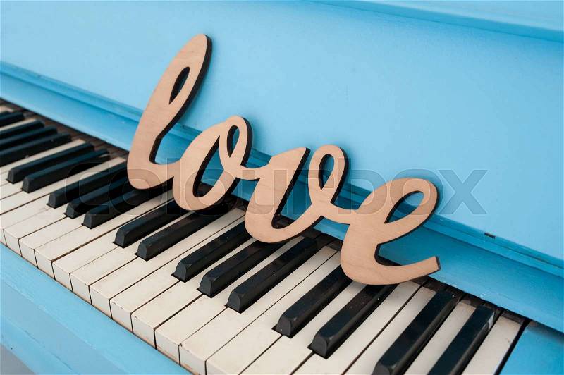 Wooden word love on piano wedding concept, stock photo
