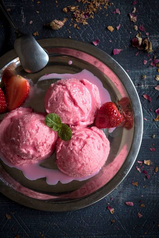 Strawberries ice cream melting in the plate,selective focus , stock photo