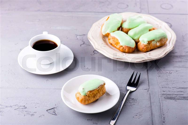 Breakfast with mint eclairs and cup of coffee, stock photo