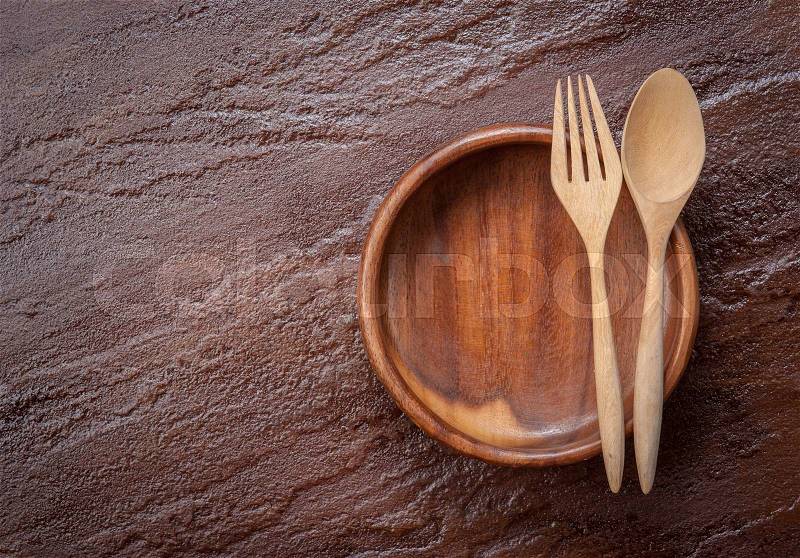 Empty bowl with fork and spoon on stone background,Top view, stock photo