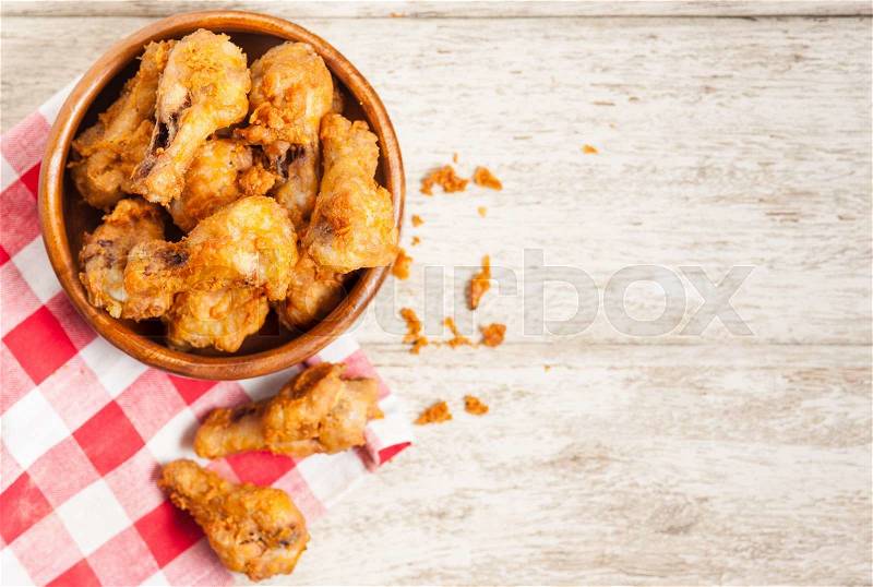 Fried crispy chicken wings on a wood table, stock photo
