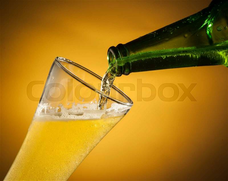 Pouring beer into glass, stock photo