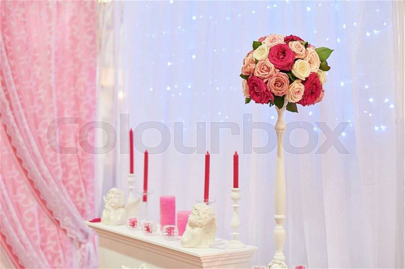 Decor of candles and flowers at the wedding table in a restaurant, stock photo