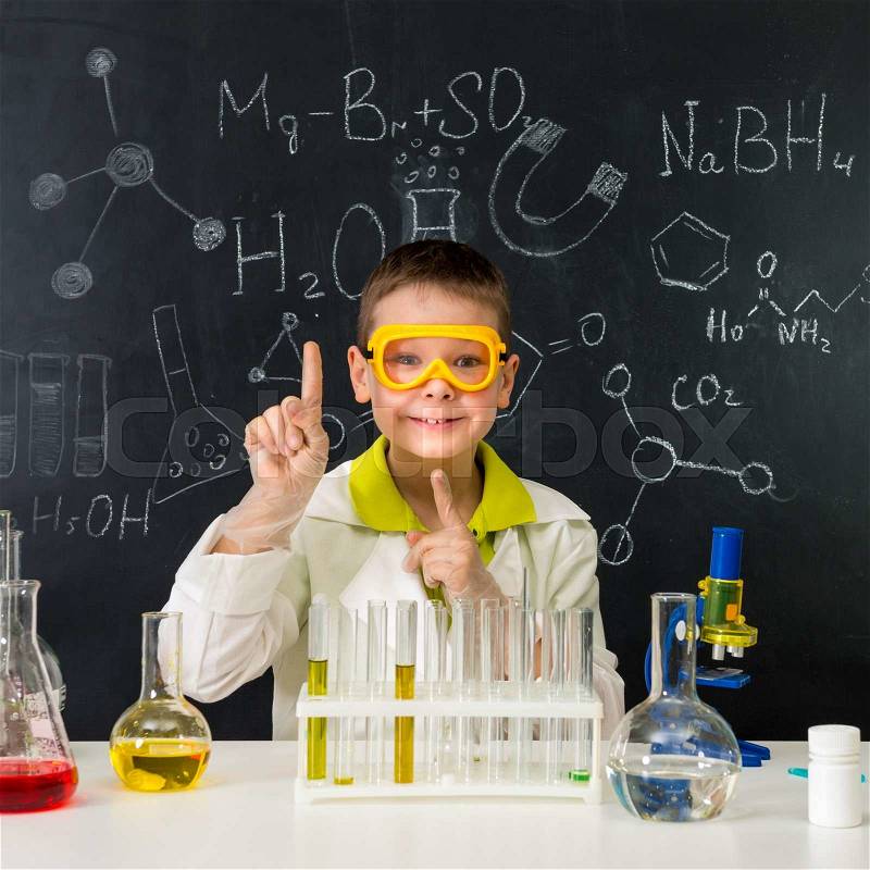 Schoolboy in chemistry lab got an idea practising experiments, stock photo