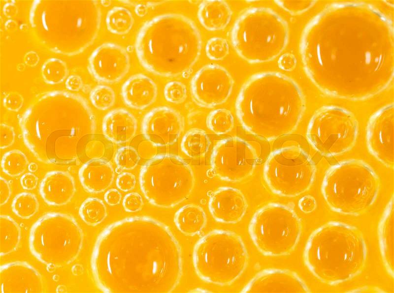Foam on a yellow egg yolk as a background. macro, stock photo