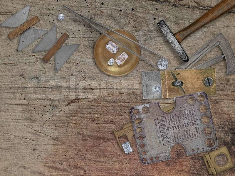 vintage jeweler tools and diamonds over wooden bench, space for your business name, stock photo