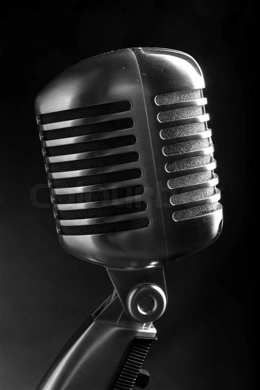Vintage microphone on black background, stock photo