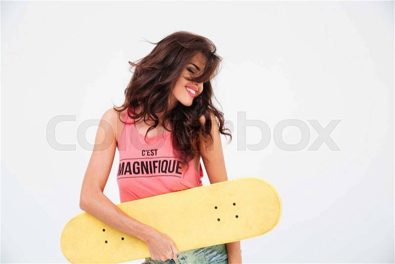 Happy relaxed woman posing with skateboard isolated on a white background, stock photo