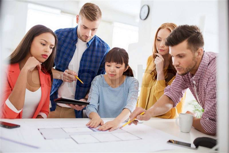 Business, startup, education and people concept - creative architect team or students with blueprint working at office, stock photo