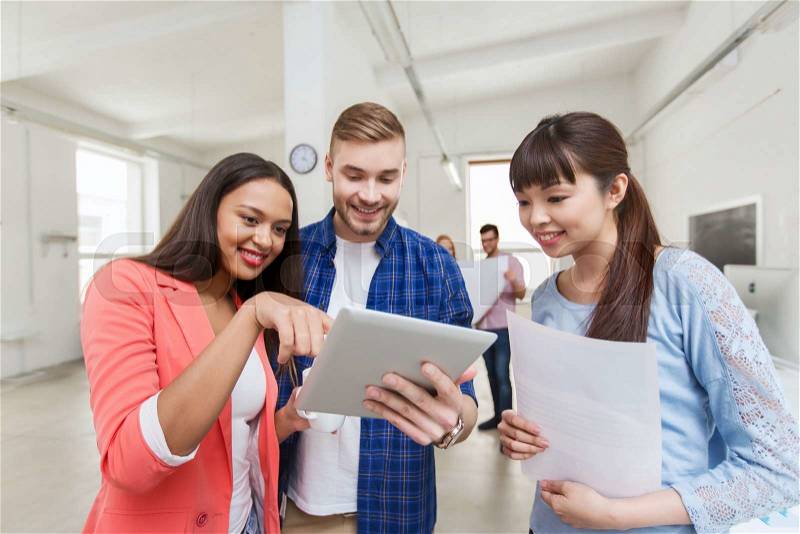Business, communication, startup and people concept - happy multiracial creative team or students with tablet pc computer and papers on coffee break talking at office, stock photo
