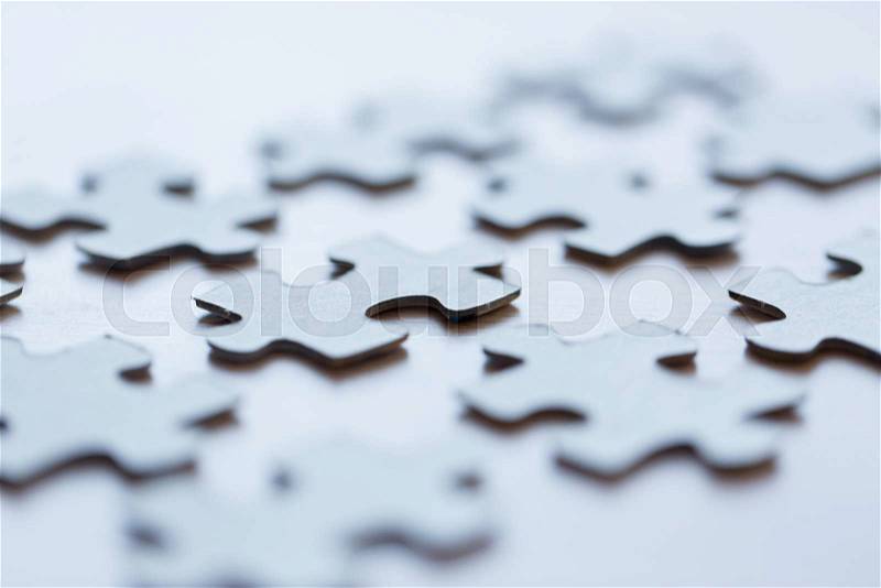 Business and connection concept - close up of puzzle pieces on table, stock photo
