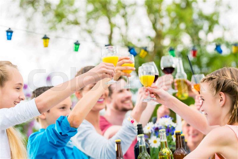 Friends and neighbors toasting on garden party, stock photo