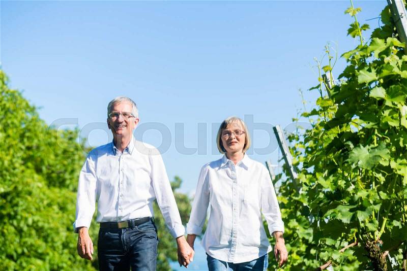 Senior woman and man having walk in summer, stock photo