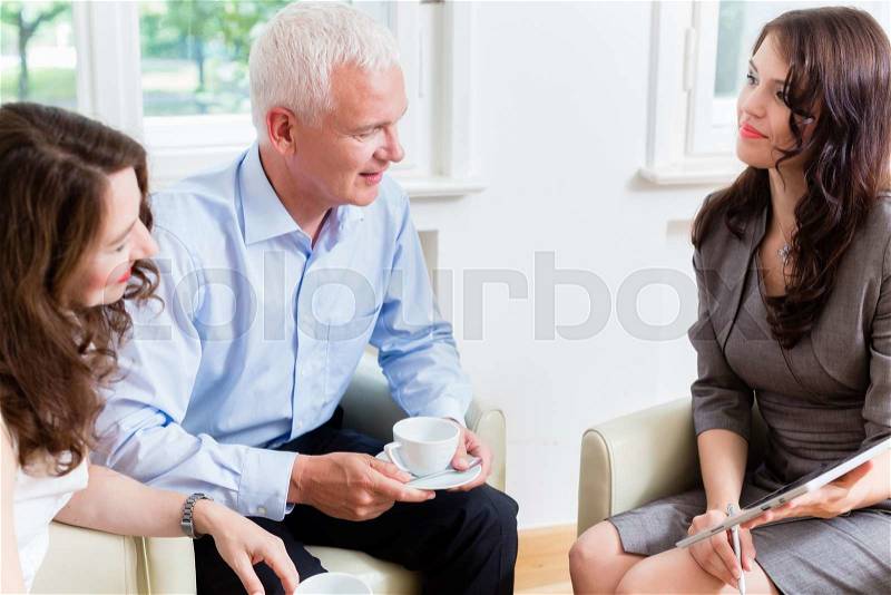 Advisor giving investment and retirement advice to senior woman and man, stock photo