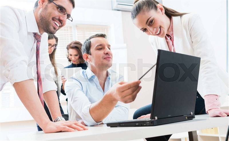 Business team reporting to boss having meeting in office, stock photo