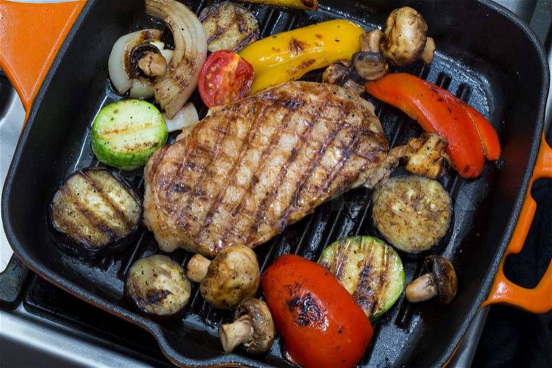 Cooking steak and mushrooms on the grill pan, stock photo