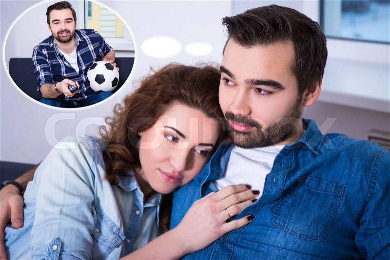 Relationship concept - cute young woman and her boyfriend dreaming about watching football on tv, stock photo