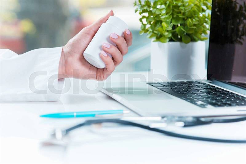 Healthcare and medical concept. Doctor with pill in hospital, stock photo