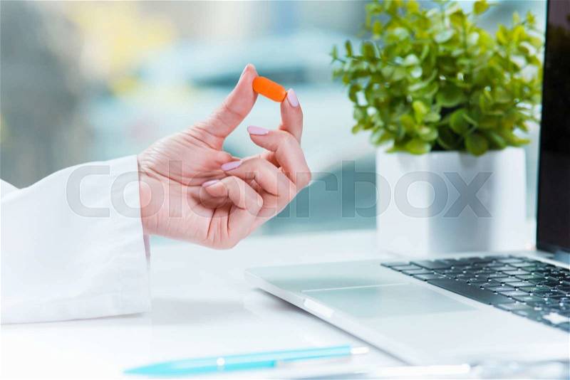 Healthcare and medical concept. Doctor with pill in hospital, stock photo