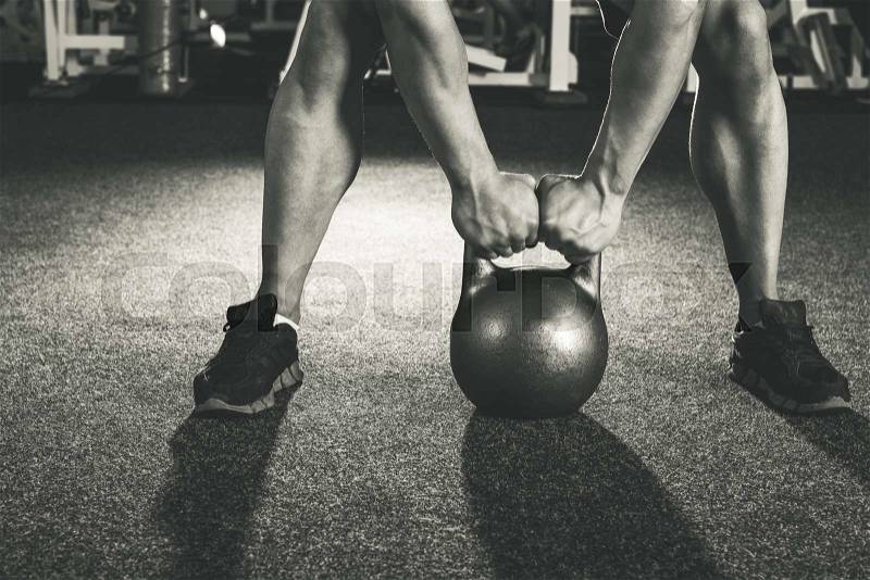 Crossfit kettlebell training in gym, stock photo