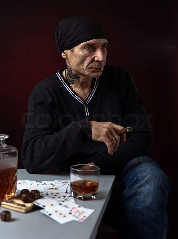 Man with whiskey and cigar, studio shot, stock photo