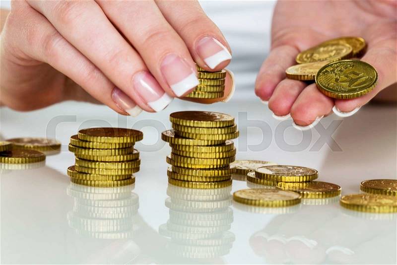 A woman stacking coins. save money for the future, stock photo