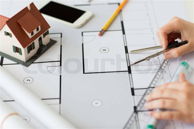 Business, architecture, building, construction and people concept - close up of architect hands with compass and ruler measuring living house blueprint, stock photo