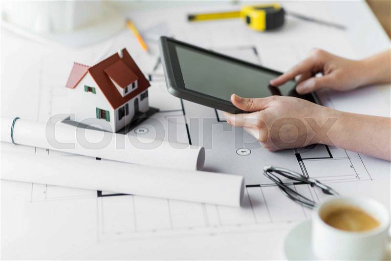 Business, architecture, building, construction and people concept - close up of architect hand with living house blueprint and tablet pc computer, stock photo