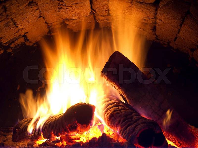 Fire in fireplace. Closeup of firewood burning in fire, stock photo