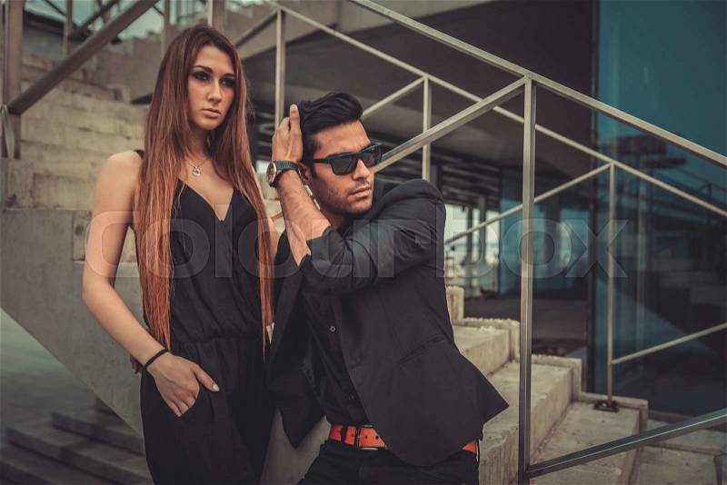 Young trendy man and woman models posing of the modern street. Fashion Style, stock photo