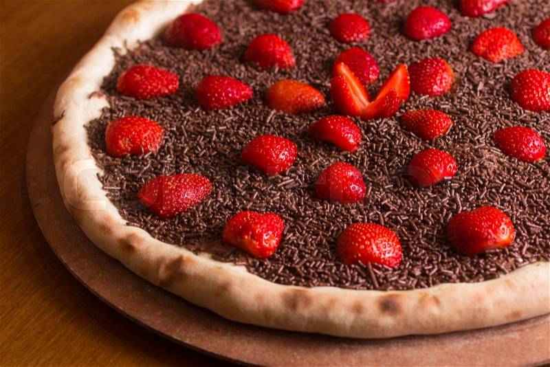 Chocolate Pizza Dessert with strawberry and sprinkles, stock photo