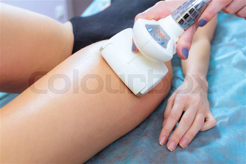 Closeup vacuum roller massage on girl legs, correction of body shape. Weight loss and anti-cellulite program. Figure correction and massage in the professional beauty clinic, stock photo