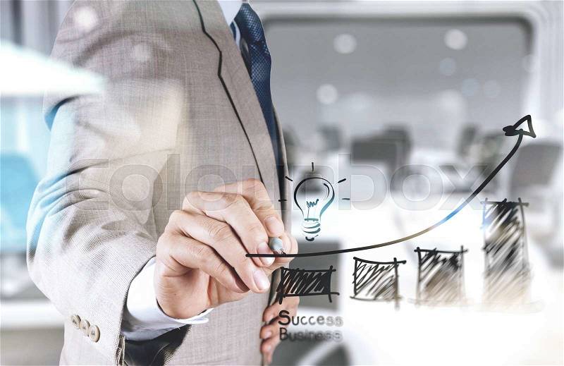 Double exposure of businessman hand draws business success chart concept on virtual screen, stock photo
