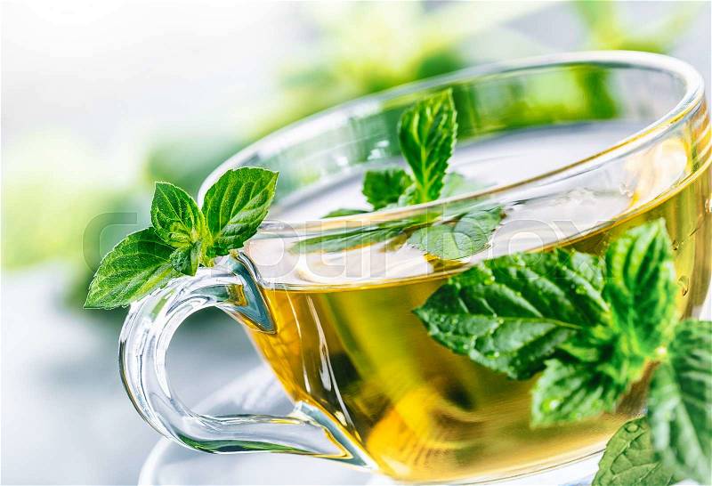 Tea. Mint Tea. Herbal tea. Mint leaf. Mint leaves. Tea in a glass cup, mint leaves, dried tea, sliced lime. herbs tea and mint leaves on a slate plate in a restaurant or teahouse tea room, stock photo
