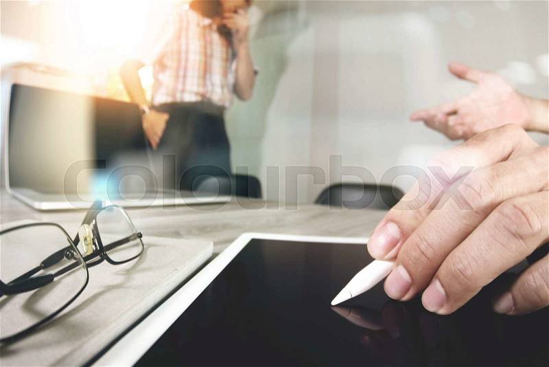 Businessman making presentation with his colleagues and business tablet digital computer at the office as concept , stock photo