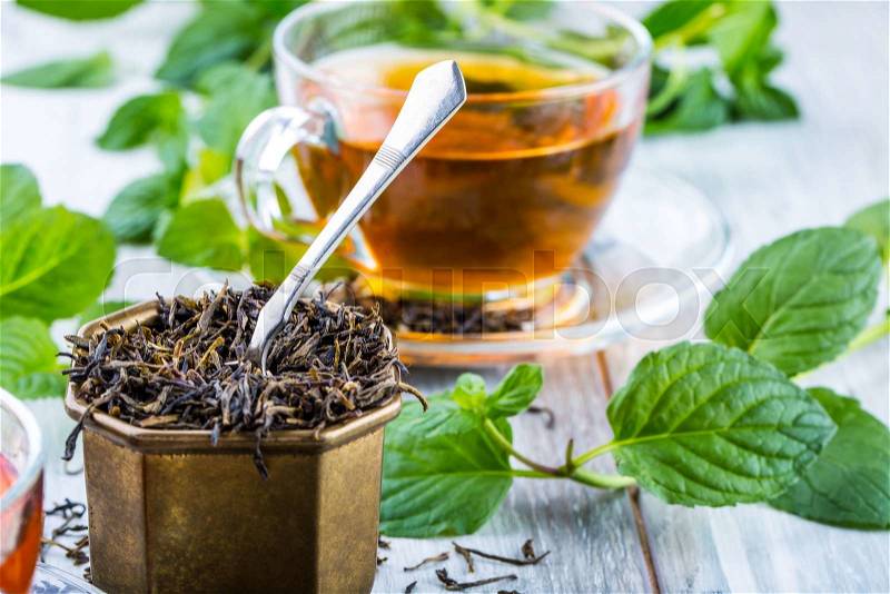 Tea. Mint Tea. Herbal tea. Mint leaf. Mint leaves. Tea in a glass cup, mint leaves, dried tea, sliced lime. herbs tea and mint leaves on a slate plate in a restaurant or teahouse tea room, stock photo